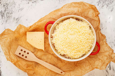 Casserole with grated cheese on top. Fish, chicken, pasta, potatoes, vegetables, meat, homemade cozy slow food. Top view.の写真素材
