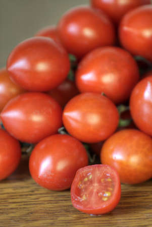 Fresh little red tomatoes on a tableの写真素材