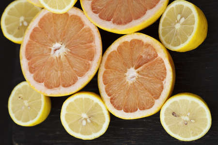 Group of fresh citrus fruits on a table, mandarines, clementines, tangerines, oranges, lemons, grapefruitsの写真素材