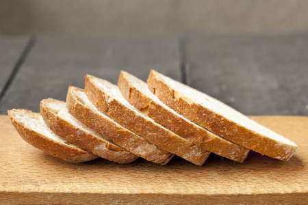 Fresh baked tasty bread on a wooden table の写真素材