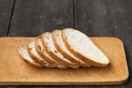 Fresh baked tasty bread on a wooden table 