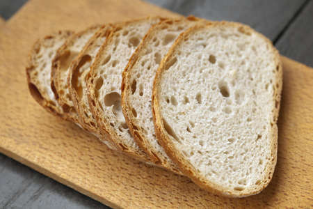 Fresh baked tasty bread on a wooden table 