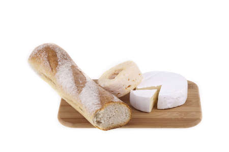 Tasty cheeses on a wooden desk with baguette. Studio photo on white backgroundの写真素材
