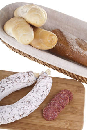 Tasty salami sausage with bread on a wooden desk  Studio photo on white backgroundの写真素材