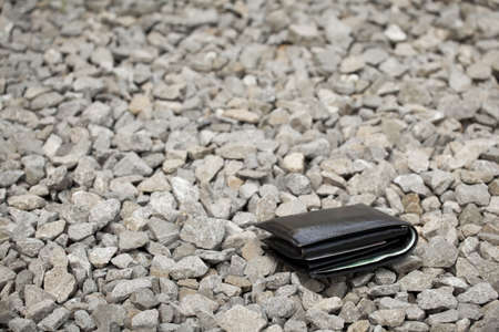 Lost black leather wallet with money lost at sidewalkの写真素材