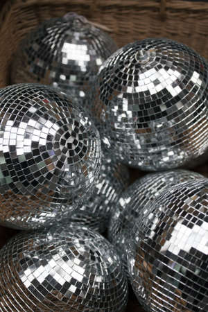 Silver and shiny disco balls in a market box.の写真素材