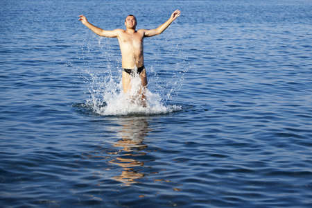 Young adult man having fun in a sea in Greece - Rhodos