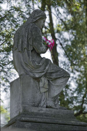 Old cemetery angel sculpture made of stoneの写真素材