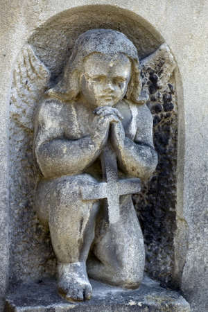 Old cemetery angel sculpture made of stoneの写真素材