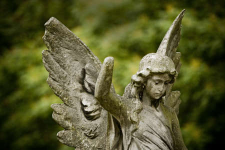 Old cemetery angel sculpture made of stoneの写真素材