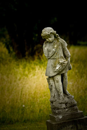 Old cemetery angel sculpture made of stoneの写真素材