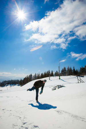 Happy young man portrait in beautiful mountain landscape taken in polish Beskidy mountain during sunny day.の写真素材