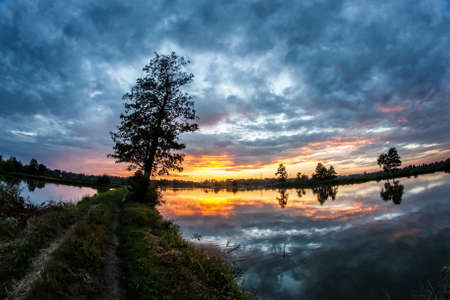 Beautiful sunset at the lakeの写真素材
