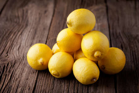 Group of fresh lemon on an old vintage wooden tableの写真素材