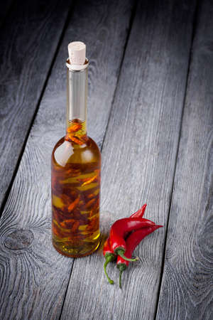 Homemade DIY natural infused olive oil with red chili peppers の写真素材