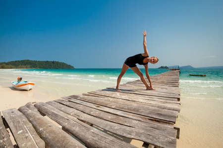 Summer yoga session on a beach - tropical Koh Rong island, Cambodiaの写真素材