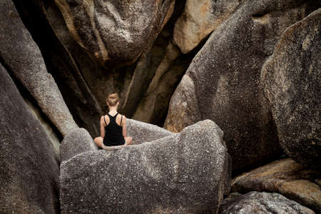 Summer yoga session on rocks - tropical Koh Samui island, Thailand. Meditation - lotus pose - padma asanaの写真素材
