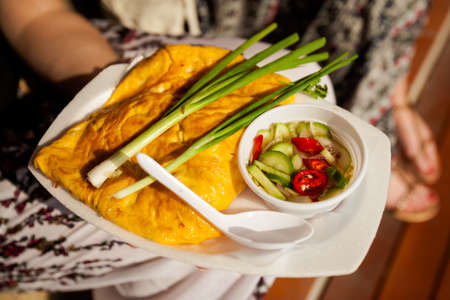 Fresh fried egg omelette served with chilli and cucumber salad and spring onion. Traditional thai...