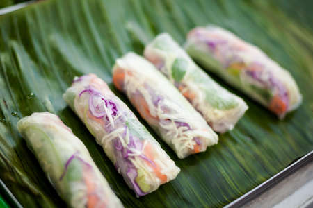 Fresh made spring rolls Poh Pia Sod. Traditional thai cuisine served on banana leafの写真素材