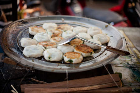 Num Kachay - chive rice flour fried cakes. Traditional cambodian street food cuisine.の写真素材