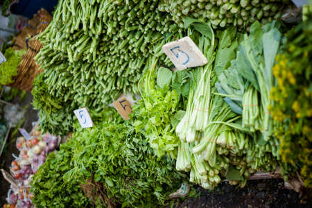 Selection of fresh green herbs and vegetables. Traditional thai market.の写真素材