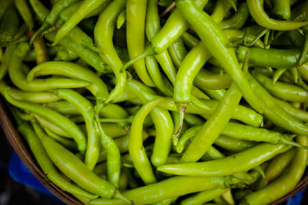 Fresh green hot chilli peppers. Traditional thai market.の写真素材