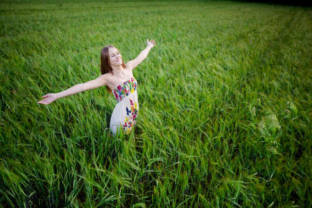 Attractive young woman relaxing in a beautiful grenn meadowの写真素材
