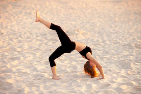 Summer yoga session on a beautiful golden beach - polish Grzybowo village, near to Kolobrzeg....