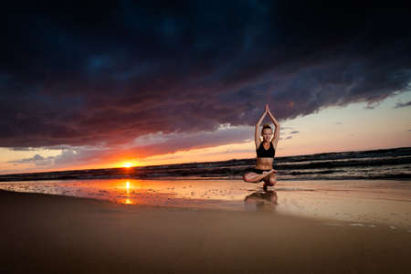 Summer yoga session on a beautiful golden beach - polish Grzybowo village, near to Kolobrzegの写真素材