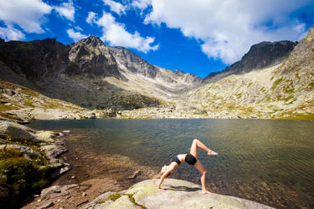 Exercise yoga everywhere - in slovakian Tatry mountains. Beautiful panorama - Chata Teryho, kotlina Piatich SpiÅ¡skÃ½ch pliesの写真素材