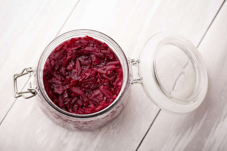 Homemade DIY natural healthy sweet and sour pickled beetroot in glass jar on a wooden tableの写真素材