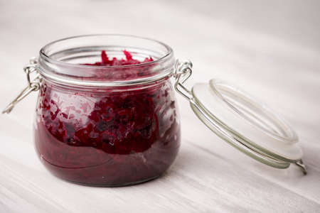 Homemade DIY natural healthy sweet and sour pickled beetroot in glass jar on a wooden tableの写真素材