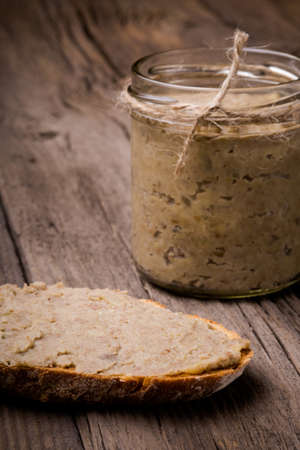 Homemade DIY natural vegan very healthy green lentil paste with rye bread and in a glass jar on a...