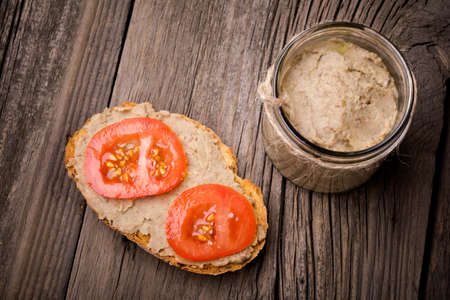 Homemade DIY natural vegan very healthy green lentil paste with rye bread and tomatoes in a glass...
