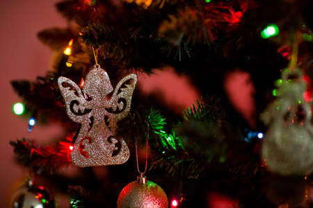 Christmas concept photo - beautiful christmas tree detail on a background of multicolor lamps