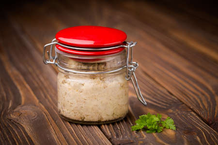 Homemade DIY natural vegan very healthy sunflower seeds paste in a glass jar on a wooden table