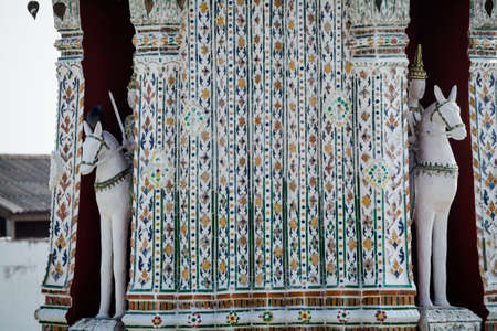 Ancient thai buddhism temple sculptures of Wat Arun. Tracional  asian architecture of Bangkok.