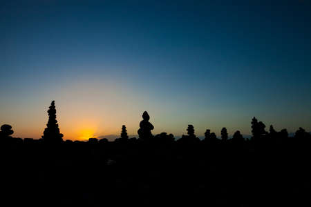 Summer sunset seascape with stone pile stacks silhouettes on tropical island Tenerife, Canary in Spain. Tranquil scene on Playa del Duque.の写真素材