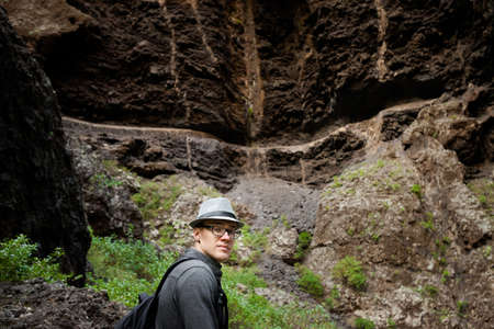 Young caucasian male tourist on mountain landscape on tropical island Tenerife, Canary in Spain....