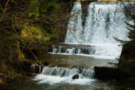 Beautiful scenic landscape of waterfall in Beskid mountains. Rysianka with a little bit of snow in...
