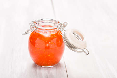 Homemade DIY natural very hot pepper - habanero and garlic sauce on a beautiful wooden tableの写真素材