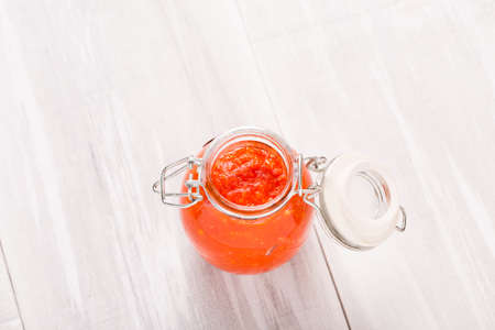 Homemade DIY natural very hot pepper - habanero and garlic sauce on a beautiful wooden table
