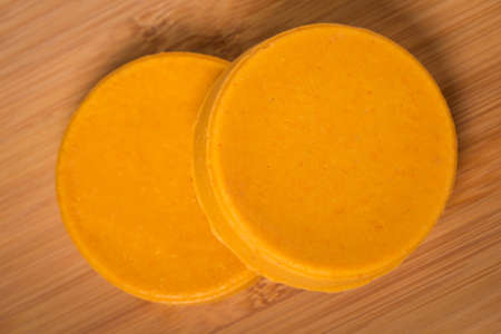 Homemade DIY natural vegan healthy yellow cheese made of potatoes, carrot and nutritional yeast a...