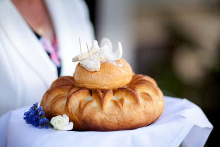 Wedding bread with salt detail on hands - traditional polish inviting to Bride and Groom.