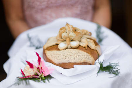 Wedding bread with salt detail on hands- traditional polish inviting to Bride and Groom.の写真素材