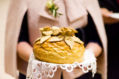 Wedding bread with salt detail on hands- traditional polish inviting to Bride and Groom.の写真素材