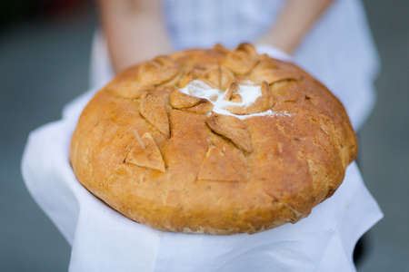 Wedding bread with salt detail on hands- traditional polish inviting to Bride and Groom.