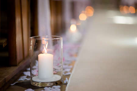 Christian detaill - church decoration for wedding marriage ceremony. Romantic candles concept.の写真素材