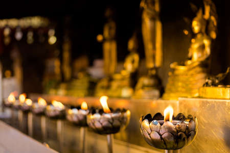 Beautiful buddhist Wat Phra That Doi Suthep temple in Chiang Mai in northern Thailand. Candles...