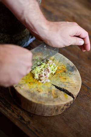 Traditional way of preparing lemon grass using chopper knife. Picture of traditional thai cuisine made of fresh ingredients taken during cooking class in Chiang Mai.の写真素材